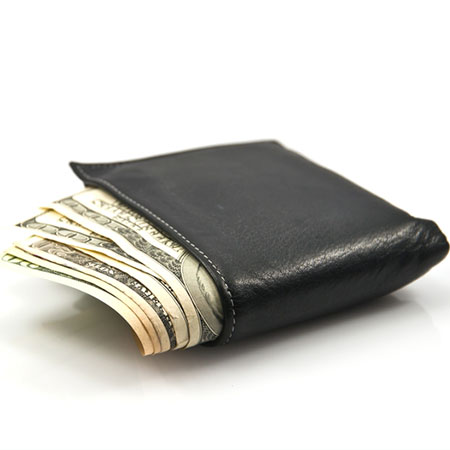 A black wallet with two 100-dollar and two 20-dollar bills hanging out